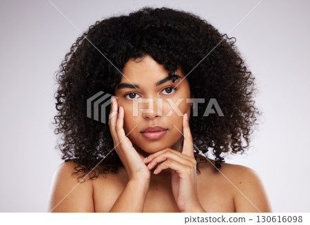 Dermatology, cosmetics and facial portrait of black woman with hand on face, afro and advertising luxury makeup. Skincare, beauty and skin care product promo on model isolated on studio background. Dermatology, cosmetics and facial portrait of black woman with hand on face, afro and advertising luxury makeup. Skincare, beauty and skin care product promo on model isolated on studio background. 130616098