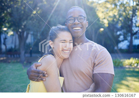 Happy interracial couple, hug and laughing in joy for bonding relationship together in the park. Man hugging woman smiling in happiness for love, embrace and sharing a laugh for funny joke in nature Happy interracial couple, hug and laughing in joy for bonding relationship together in the park. Man hugging woman smiling in happiness for love, embrace and sharing a laugh for funny joke in nature 130616167