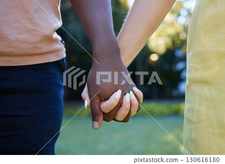 Interracial, couple holding hands and trust, love outdoor in nature and commitment, support in relationship. Together in park, black man with woman, hand zoom and care, romantic date with partnership 130616180