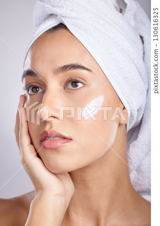 Woman, head towel and cream for skincare, wellness and organic facial for face detox on grey studio background. Female, lady or makeup for natural beauty, confident and cosmetics for grooming routine Woman, head towel and cream for skincare, wellness and organic facial for face detox on grey studio background. Female, lady or makeup for natural beauty, confident and cosmetics for grooming routine 130616325