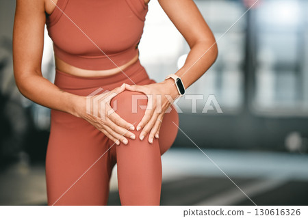 Woman, exercise and knee pain with injury, fitness and workout in sportswear, muscle tension and sports. Leg massage, female athlete and lady with inflammation, training accident and joint sprain 130616326