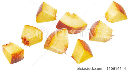 Falling peach slices isolated on white background with clipping path, fresh nectarine cubes 130616344