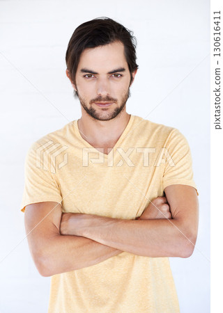 Man, arms crossed and serious fashion portrait isolated on a white background with mockup space. Face of male Europe model with a beard posing for magazine cover, advertising or marketing in studio Man, arms crossed and serious fashion portrait isolated on a white background with mockup space. Face of male Europe model with a beard posing for magazine cover, advertising or marketing in studio 130616411
