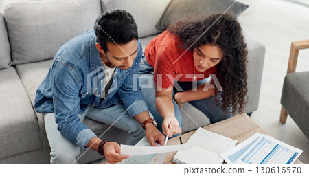 Above, couple and reading document at house for financial planning, review budget and bills invoice. People, paperwork and application for home insurance, mortgage expenses and information on payment 130616570