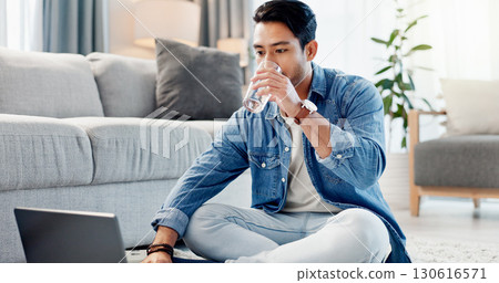 Laptop, drinking water and man in home for remote work, reading report or news update on floor. Computer, thirsty freelancer and glass beverage in lounge, review headline and article for journalism Laptop, drinking water and man in home for remote work, reading report or news update on floor. Computer, thirsty freelancer and glass beverage in lounge, review headline and article for journalism 130616571