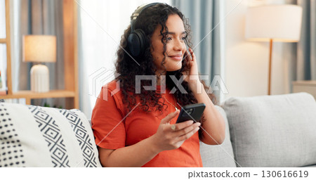 Phone, music and relax with woman on sofa for streaming service, audio app and connection. Online song album, radio subscription and headphones with person in living room of home for sound and break Phone, music and relax with woman on sofa for streaming service, audio app and connection. Online song album, radio subscription and headphones with person in living room of home for sound and break 130616619