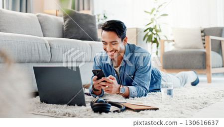 Man, laptop and phone on floor for communication, social media and video streaming or website in home. Movie, internet audio and male person by couch with technology, break and watching film on app 130616637
