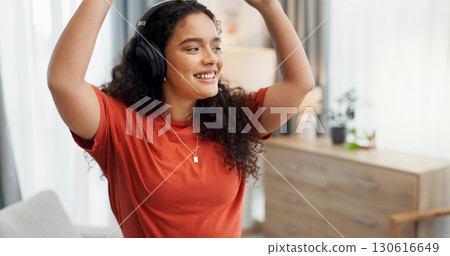 Headphones, music and dance with woman in house for streaming service, audio app or connection. Online song album, radio subscription and energy with person in living room of home for sound and break 130616649