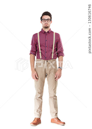 Portrait, nerd and man serious, fashion and glasses with young person isolated on white studio background. Gentleman, male and hipster with funky outfit, smart guy and suspenders with confidence Portrait, nerd and man serious, fashion and glasses with young person isolated on white studio background. Gentleman, male and hipster with funky outfit, smart guy and suspenders with confidence 130616746