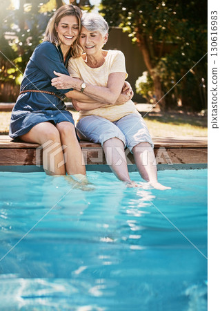 Women, hug and relax by swimming pool, love and care with quality time during summer vacation. Elderly mother, daughter and vacation, outdoor with pool and wellness lifestyle with happy family 130616983