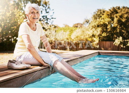 Pool, portrait and senior woman by the water while on a vacation, adventure or outdoor trip in summer. Happy, smile and elderly lady in retirement with her feet in the swimming pool at holiday resort Pool, portrait and senior woman by the water while on a vacation, adventure or outdoor trip in summer. Happy, smile and elderly lady in retirement with her feet in the swimming pool at holiday resort 130616984