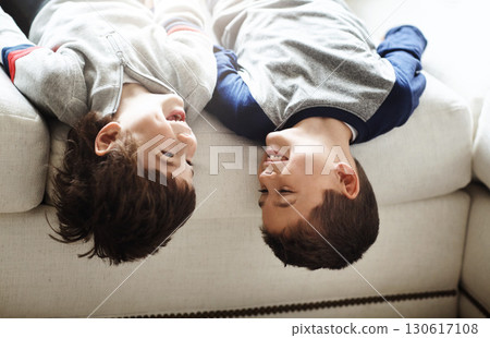 Children upside down, play and happy at family home, fun with sibling and face of brothers on sofa and relax in living room. Happy people, love and quality time together, playful kid boys and funny Children upside down, play and happy at family home, fun with sibling and face of brothers on sofa and relax in living room. Happy people, love and quality time together, playful kid boys and funny 130617108