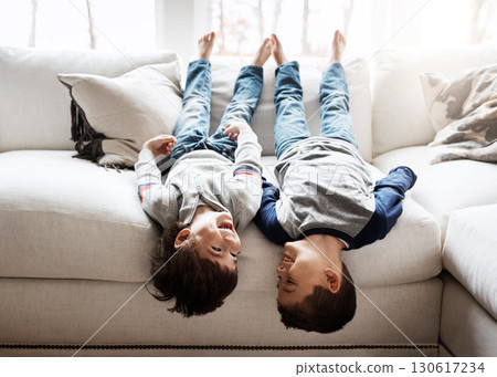 Children upside down, playing and happy at family home for fun with sibling, brothers on sofa and relax in living room. Happy people, love and quality time together, playful kid boys with laughing Children upside down, playing and happy at family home for fun with sibling, brothers on sofa and relax in living room. Happy people, love and quality time together, playful kid boys with laughing 130617234