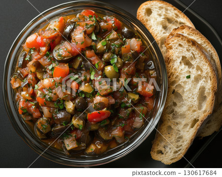 Eggplant caponata with a sweet and sour mix of tomatoes, olives, capers, and onions 130617684