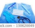 Healthcare background of disposable face mask, gloves, cap, goggles, scrubs and stethoscope laying on table flat lay view 130620049