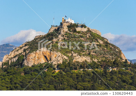 Lycabettus Hill with Saint George chapel under blue sky in Athens, Greece. Lycabettus Hill with Saint George chapel under blue sky in Athens, Greece. 130620443