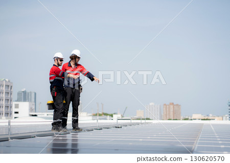 Team engineer and technician working on solar panel installation at rooftop. 130620570
