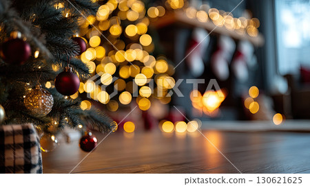 living room decorated for Christmas, warm yellow fairy lights, Christmas tree with ornaments, fireplace with stockings 130621625