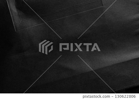 Black textured crumpled decorative paper with geometric pattern. Old rough cardboard surface. Abstract dark background Black textured crumpled decorative paper with geometric pattern. Old rough cardboard surface. Abstract dark background 130622806