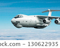 White wide body transport cargo aircraft flying in the air above the clouds 130622935