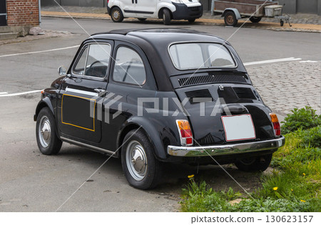 Small black vintage car on the street. Bornholm, Denmark 130623157