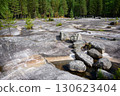 Rocky landscape with ancient rock art, stones and water in northern forest, prehistoric drawing in Zalavruga, nature of Russia 130623404