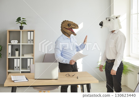 Two businessmen in animal masks working in office 130623440