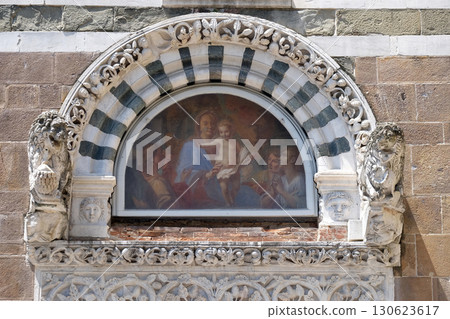 Virgin Mary with baby Jesus, lunette on the portal of San Giusto church in Lucca, Tuscany, Italy 130623617