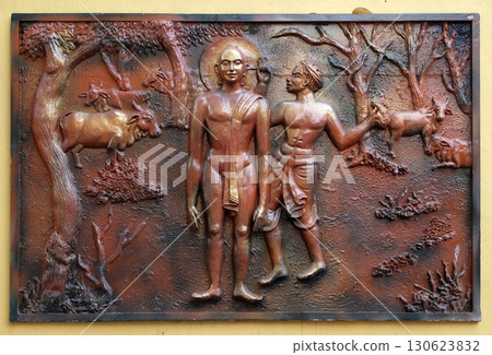 Bhagavan Mahaviras ears plugged with neddle - like wooden pegs, Street bass relief on the wall of Jain Temple (also called Parshwanath Temple) in Kolkata, West Bengal, India 130623832