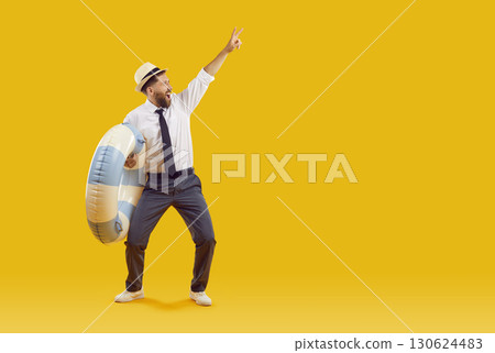 Funny office worker with inflatable ring advertising summer holiday on yellow copy space background Funny office worker with inflatable ring advertising summer holiday on yellow copy space background 130624483
