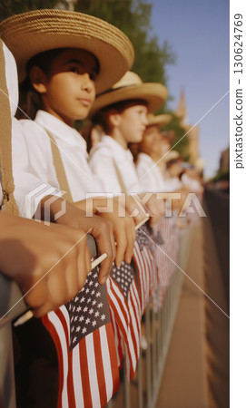 Close-up young children in white shirts suspenders cowboy hats holding American flags along fence cinematic Hasselblad photography high realism ultra-realistic patriotic parade stock photo 130624769