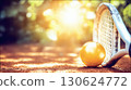 Tennis racket and ball close up on sunlit ground with blurred park background. Warm tones and natural lighting create sport concept ideal for fitness health design or competition poster 130624772