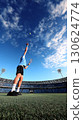 Professional tennis player serving ball with motion blur in dynamic stadium scene with empty sky space. Ideal for sport competition promotion fitness training or motivational poster 130624774