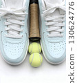Flat lay of tennis shoes and racket on clean white background with copy space. Minimalist sport design concept perfect for product presentation advertising or healthy lifestyle poster 130624776