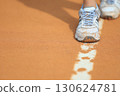 Close up of tennis shoes footprints on clay court near baseline with morning sunlight. Sport background concept for competition training healthy lifestyle promotion or fitness poster design 130624781