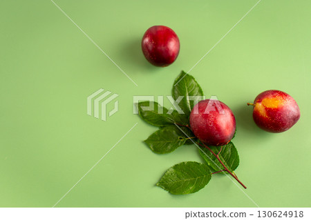 Three juicy plums with a blush close-up on the table Three juicy plums with a blush close-up on the table 130624918