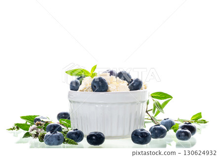 Healthy breakfast cottage cheese with blueberries on a white background Healthy breakfast cottage cheese with blueberries on a white background 130624932
