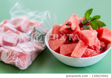Fresh watermelon cubes in white bowl and frozen package 130624942