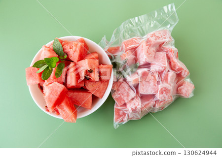 Summer concept with fresh and frozen watermelon fruit cubes 130624944