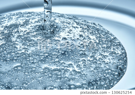 The texture of hyaluronic cleansing for the face or serum in blue tones. The texture of hyaluronic cleansing for the face or serum in blue tones. 130625254