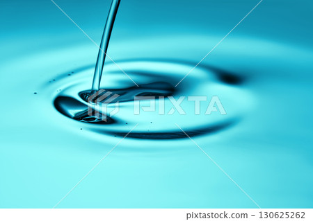 The oil flows and collects into a drop. The texture of the cosmetic product. 130625262