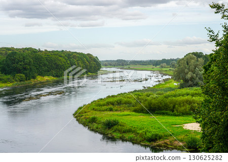 Scenic view of Lielupe River from Mezotne Castle Mound in Latvia with lush green landscape 130625282