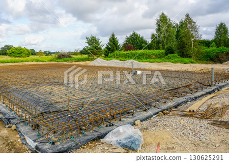 Reinforcement steel mesh grid prepared for concrete foundation slab at construction site Reinforcement steel mesh grid prepared for concrete foundation slab at construction site 130625291