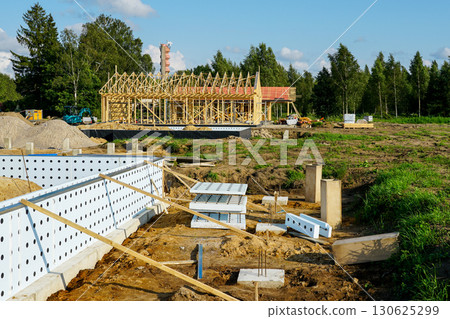 ICF foundation system with timber framing construction in background at residential building site ICF foundation system with timber framing construction in background at residential building site 130625299
