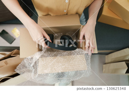 Online shopping. Unboxing new headphones from a delivery box. Online shopping. Unboxing new headphones from a delivery box. 130625348