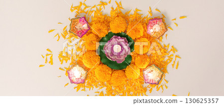 Diwali Decor. Festive arrangement of marigold flowers and decorative lamps for celebration. 130625357