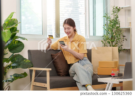 Cyber Monday joy with online shopping and credit card in hand 130625360