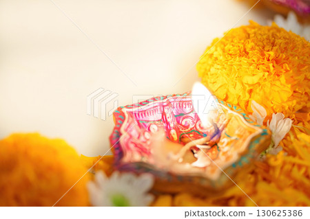 Diwali Celebration. Beautiful oil lamp surrounded by marigold flowers. 130625386