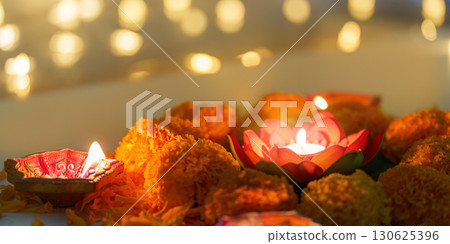 Diwali Festival. Colorful candles and marigold flowers creating a festive atmosphere. 130625396