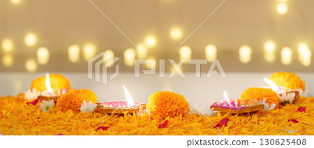 Diwali Festival. Beautifully arranged oil lamps and marigold flowers for celebration. Diwali Festival. Beautifully arranged oil lamps and marigold flowers for celebration. 130625408